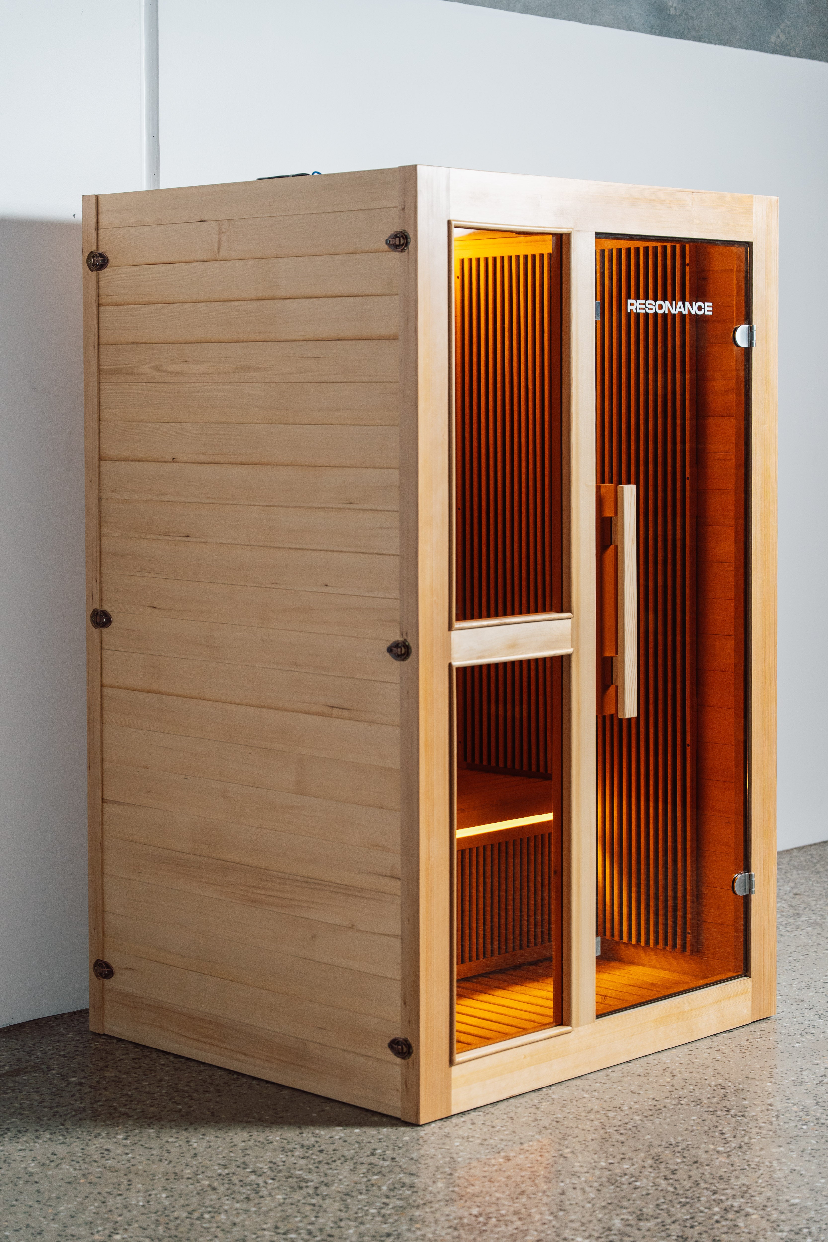 Resonance Recovery Pod front view open door — 2-person infrared sauna interior with cedar benches and heaters